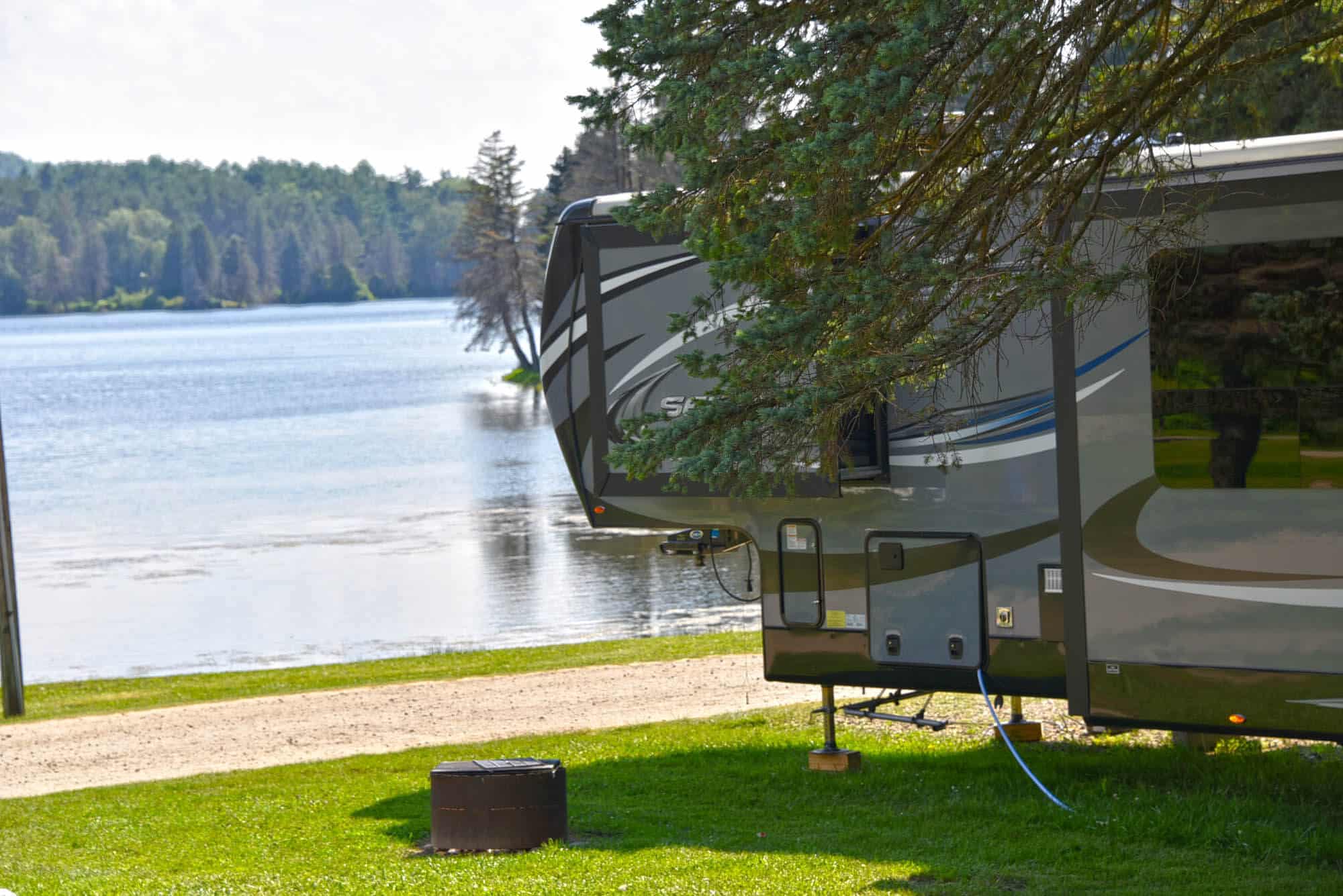 A lake-view RV site complete with water and electric hook-up, and enough space for two vehicles and a golf cart.